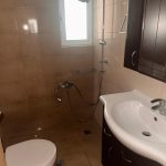 Modern tiled bathroom with sink and shower